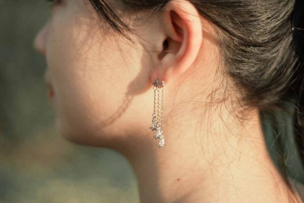 woman wear sterling silver earrings